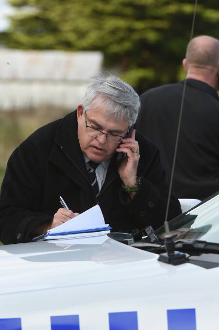 Search for answers: Ballarat Criminal Investigation Unit senior sergeant Dave Hermit attends the scene at Barkstead-Bungaree Road yesterday. 