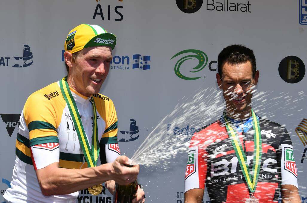 Rohan Dennis celebrated nhis third national time trial championship in a row, with third placegetter Richie Porte watching on. Picture: Lachlan Bence