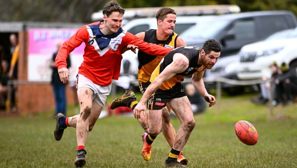 Fletcher Toose does his best to keep Skipton's Tim Hughes away from Springbank teammate Brett Maher at Wallace on Saturday. Picture by Adam Trafford.