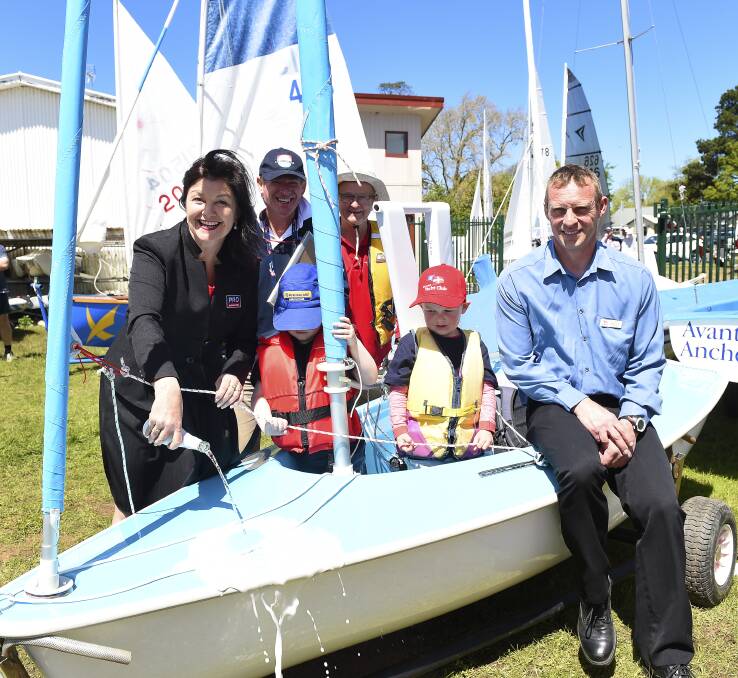 NEW CRAFT: Ballarat City councillor Sam McIntosh joins Charles Weatherly, John McKean, junior sailors Haymes Risby and Joe Herbertson, and BYC commodore Neville Bilney to christen sailability program craft "Bert". 
