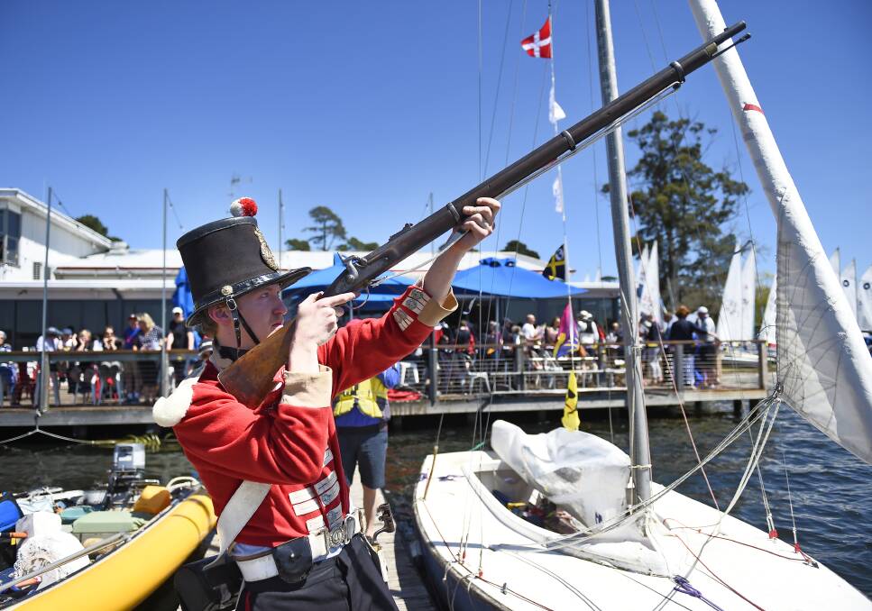 FIRE: Sovereign Hill redcoat Matthew Bourke signals the start a new sailing season for Ballarat Yacht Club on Lake Wendouree. Pictures: Luka Kauzlaric