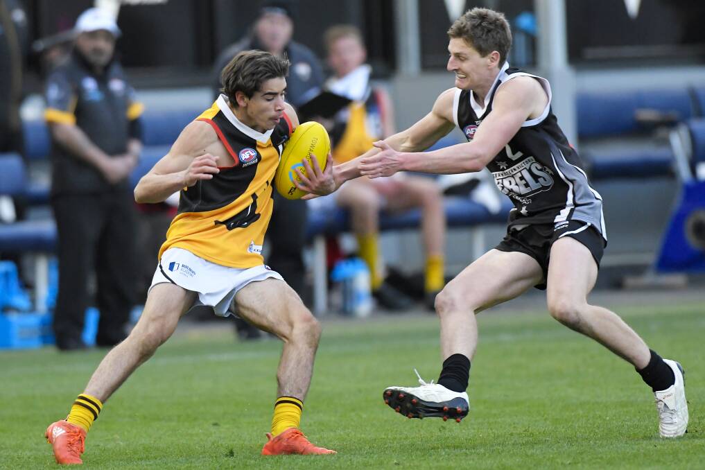 Callan Wellings, pictured tackling Toby Bedford during his Rebels days, has signed for Ballarat.