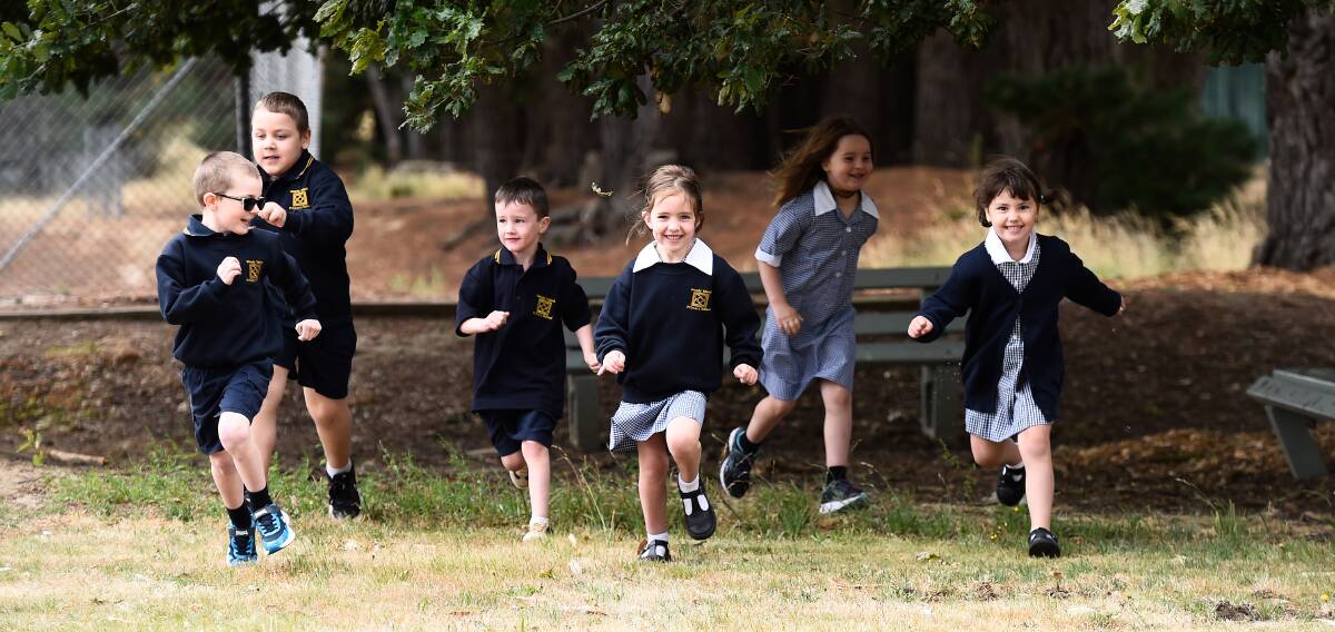 Prep pupils from Woady Yaloak Primary School's Scarsdale campus run into their new future as school students. Picture by Adam Trafford