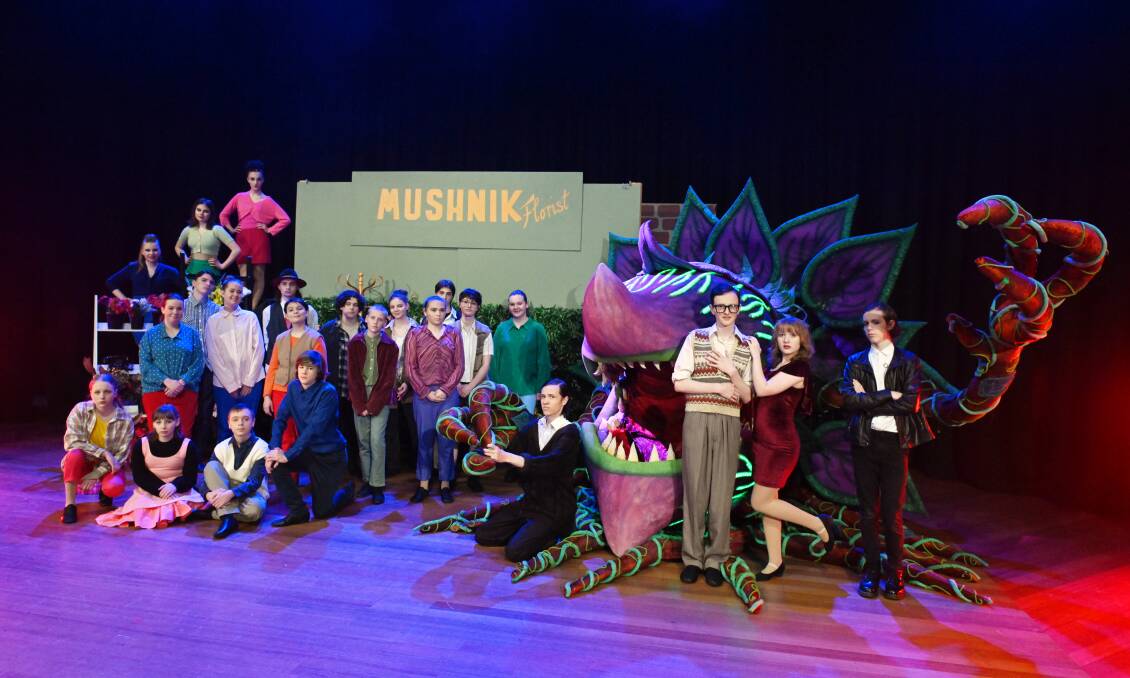 The cast of BCMA's production of Little Shop of Horrors and the giant bloodthirsty plant puppet Audrey 2. Picture by Kate Healy