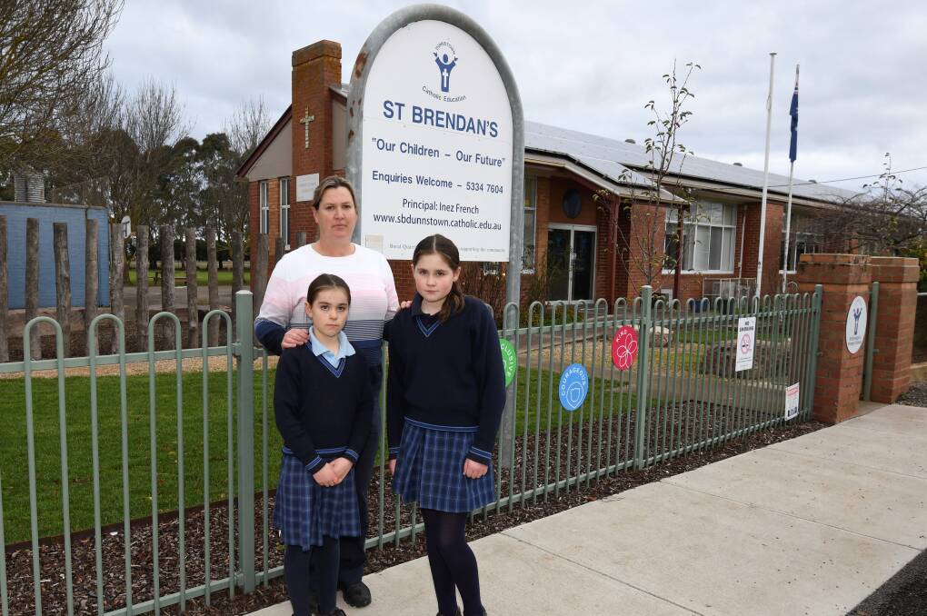Eleanor Dash with daughters Sophie, 8, and Lucy, 12, are sad that St Brendan's Primary School in Dunnstown will close at the end of the year. Picture by Lachlan Bence