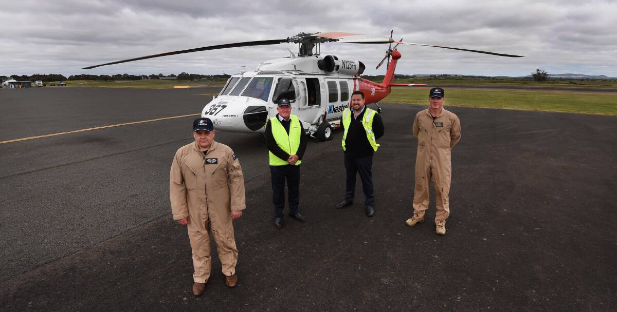 Kestrel Aviation's Jason Vodic, Ray Cronin, Justin Charlesworth and John Walsh in front of the UH-60 Black Hawk helicopter based at Ballarat Airport for the summer fire season. Picture by Lachlan Bence