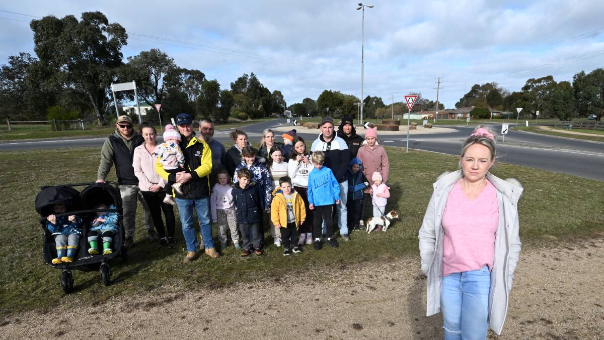 Kathryn Morris (front) and neighbours are calling for a zebra crossing to be installed on Haddon-Winderemere Road to allow children to cross safely going to and from school. Picture by Lachlan Bence