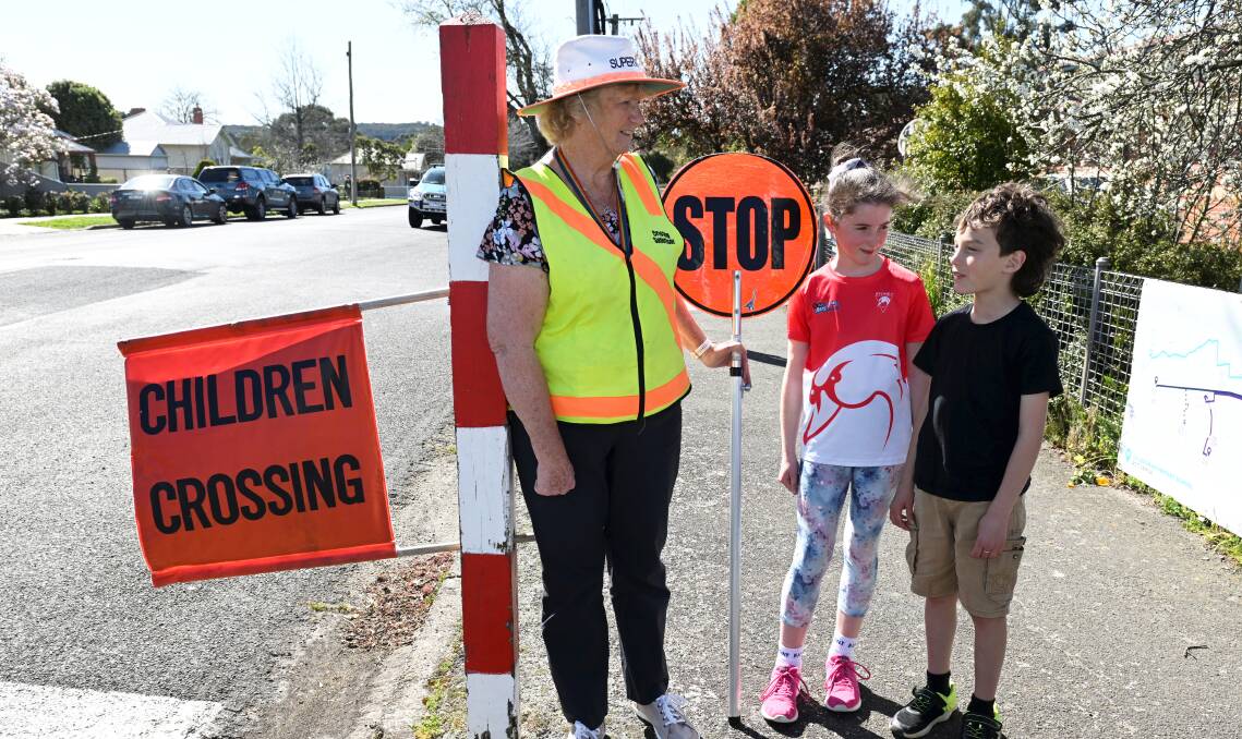 Retiring school crossing supervisor Chris Rix with Caledonian Primary School pupils Hank and Ivy. Picture by Lachlan Bence