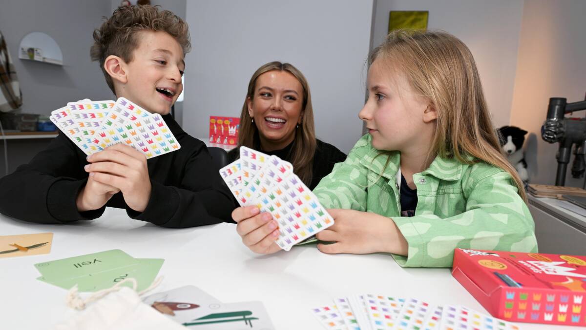 Jag, 9, and Sanna, 7, play a game using the Ballarat-designed WizWords with Shine Learning tutor Bryony Donald. Picture by Lachlan Bence