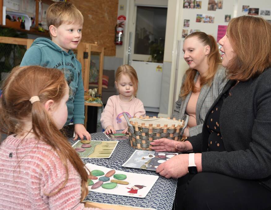Ballarat MP Catherine King with Ballarat Childcare Cooperative's Eva, Johnny, Peyton and Kristen, who has 18-month old twins attending the centre. Picture by Lachlan Bence