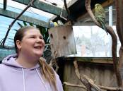 Gabriela Romeo with her budgies who now live in an outdoor aviary after four of her birds died during a suspected gas leak at her Redan home in 2023. Picture by Kate Healy