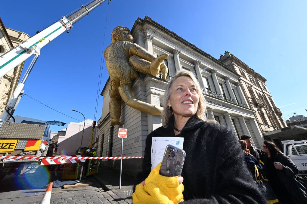 Artist Lisa Roet oversees installation of Golden Monkey on Lydiard Street. Picture by Lachlan Bence