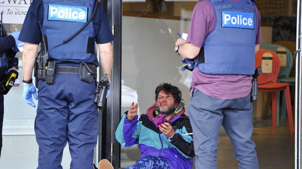 Police question a man who was assaulted on Doveton Street North on Saturday. Picture: Dylan Burns