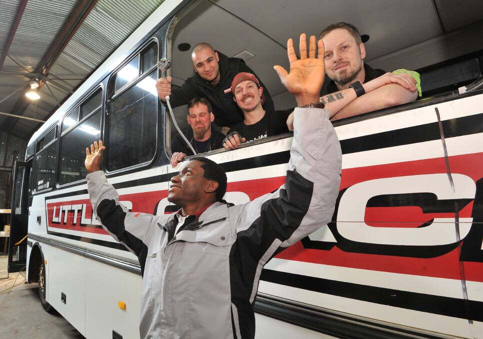 CALL FOR VOLUNTEERS: One Humanity Shower Bus build team members Michael Roach, Ryan Norman, Josh Carson, Jahi Tuppen, and committee member Constantine Osuchukwu say the bus will be up and running on September 15. Picture: Lachlan Bence.