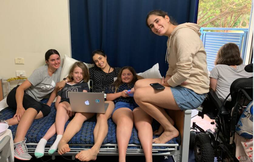 Danielle (centre) with some of her colleagues and patients. Picture supplied 