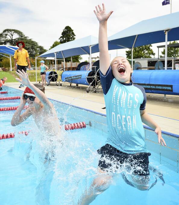 HOT CHRISTMAS: Jack Keating, 10, and Gemma Gale, 9, cool off at Eureka Pool before the temperature climbs into the thirties again for Christmas. Picture: Dylan Burns